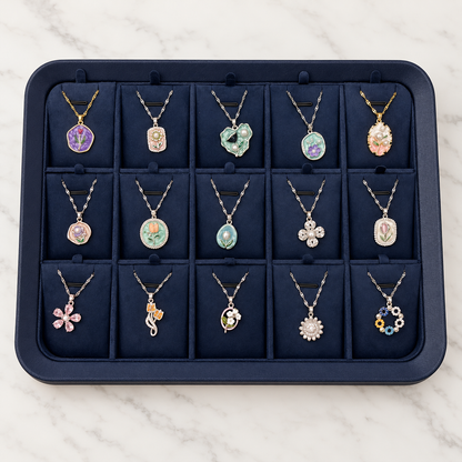 Retouched full display of 15 floral pendant necklaces, three rows of five, with navy tray included