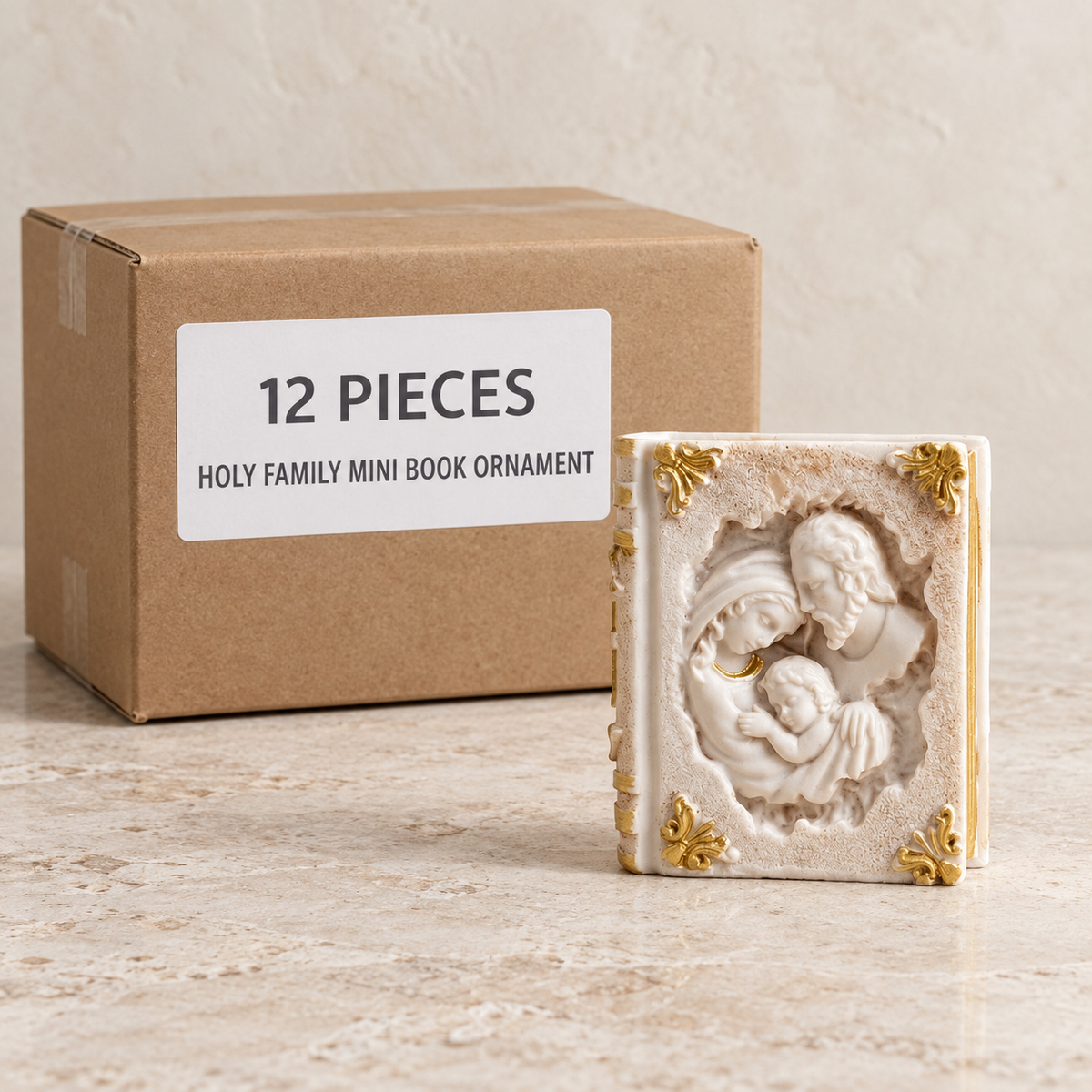 Holy Family Mini Book Ornament — Box of 12 — 12 × Holy Family Mini Book Ornament. Representative samples beside illustrative wholesale carton.