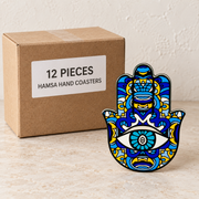 Hamsa Hand Coasters — Box of 12 — 12 × Hamsa Hand Coasters. Representative samples beside illustrative wholesale carton.