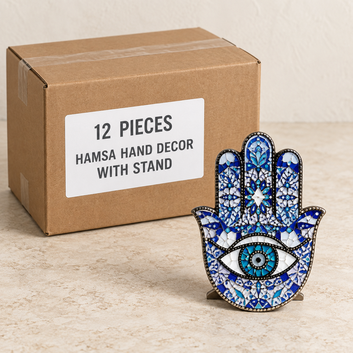 Hamsa Hand Decor with Stand — Box of 12 — 12 × Hamsa Hand Decor with Stand. Representative samples beside illustrative wholesale carton.