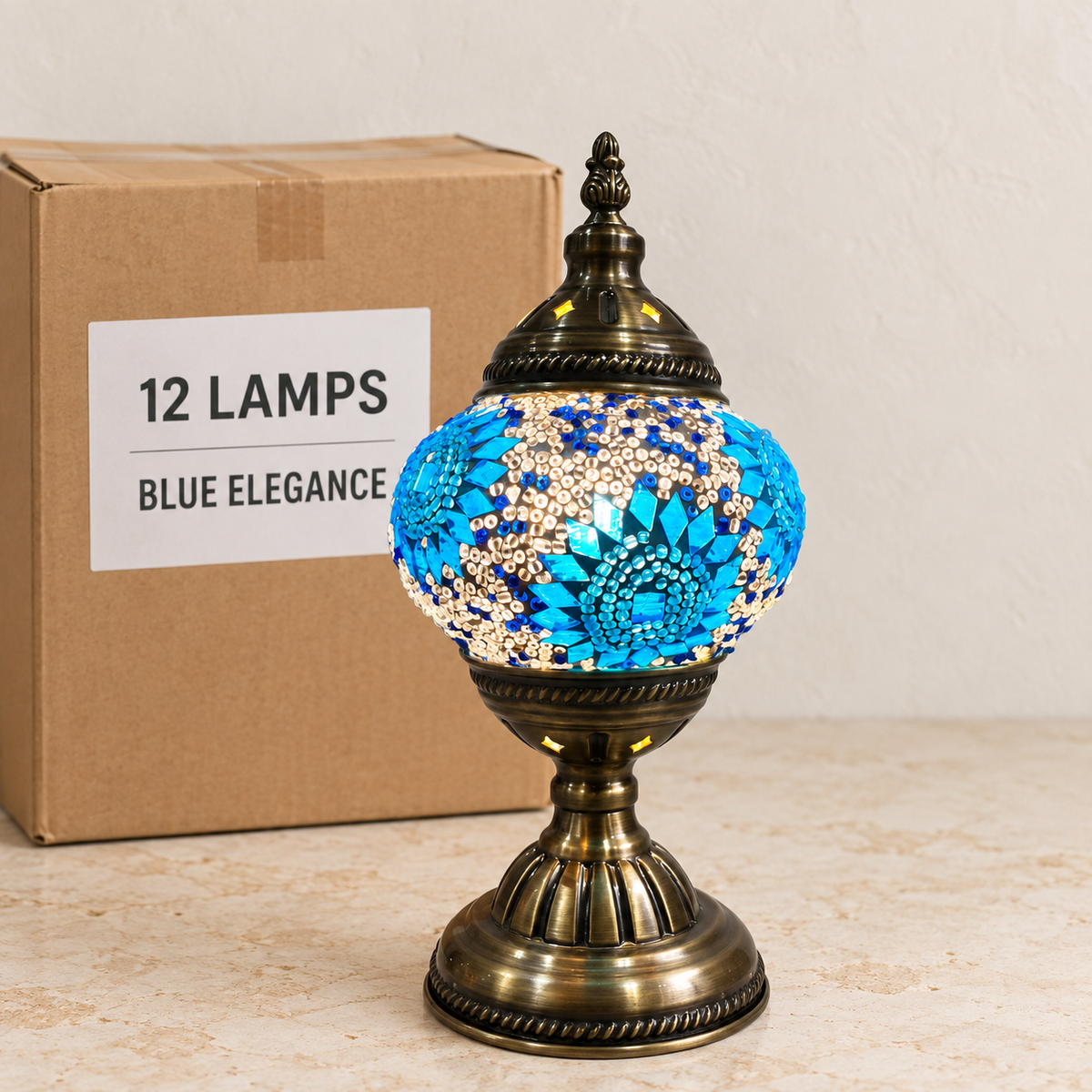 Blue Elegance mosaic table lamp, based on the original Bazaar G retail product photo. One sample shown; wholesale box contains 12 of this design. Carton illustration.