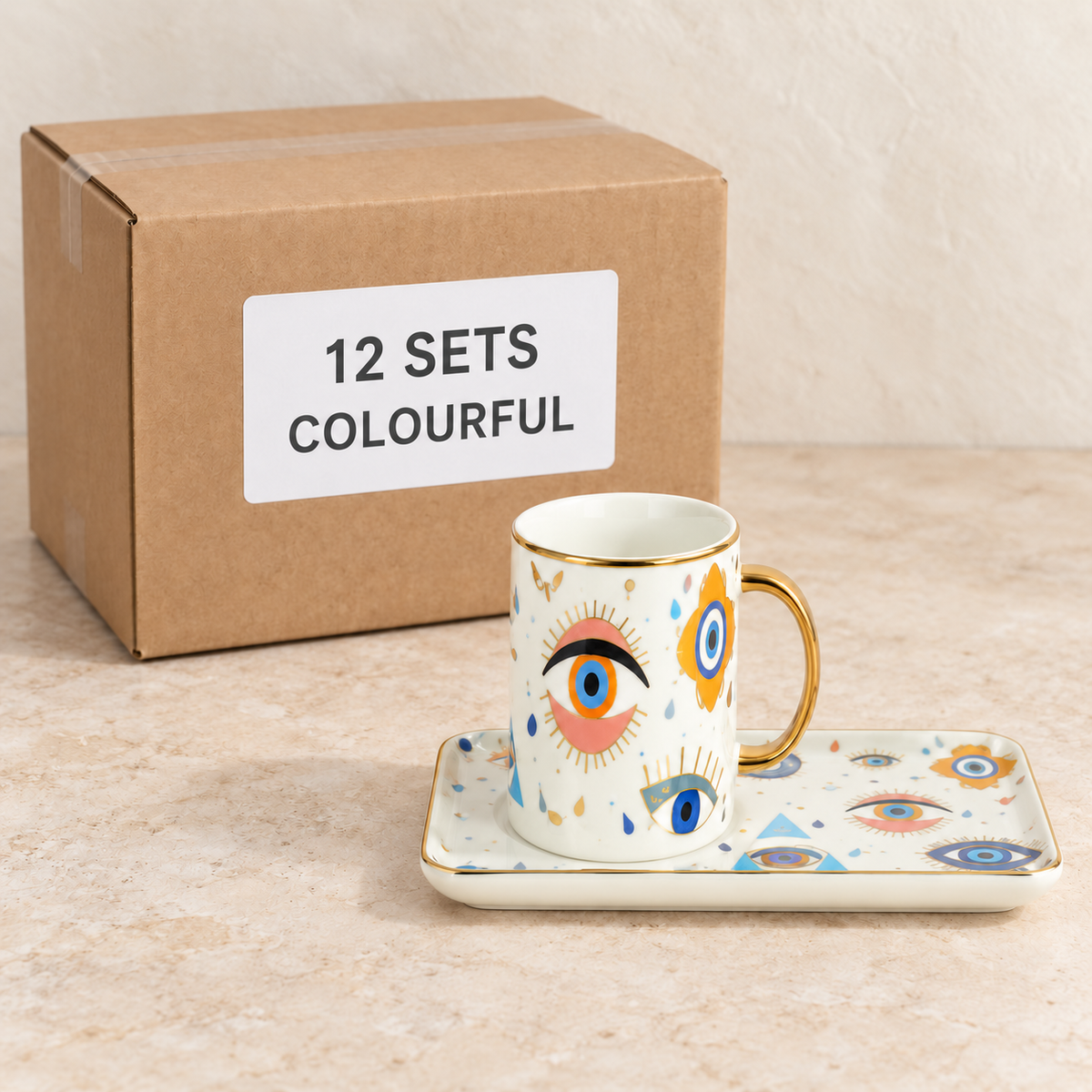 Evil Eye Mugs with Rectangular Trays — Box of 12 — 12 × Colourful. Representative samples beside illustrative wholesale carton.