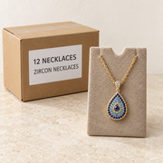 Necklaces — Box of 12 — 12 × Zircon Necklaces. Representative samples beside illustrative wholesale carton.