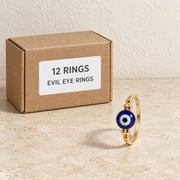 Rings — Box of 12 — 12 × Evil Eye Rings. Representative samples beside illustrative wholesale carton.