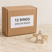 Rings — Box of 12 — 12 × Zircon Rings. Representative samples beside illustrative wholesale carton.